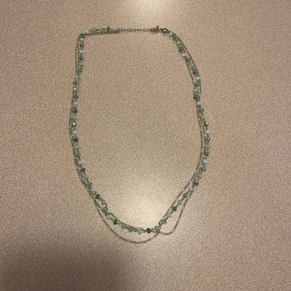 Long Green, white, and silver beaded necklace